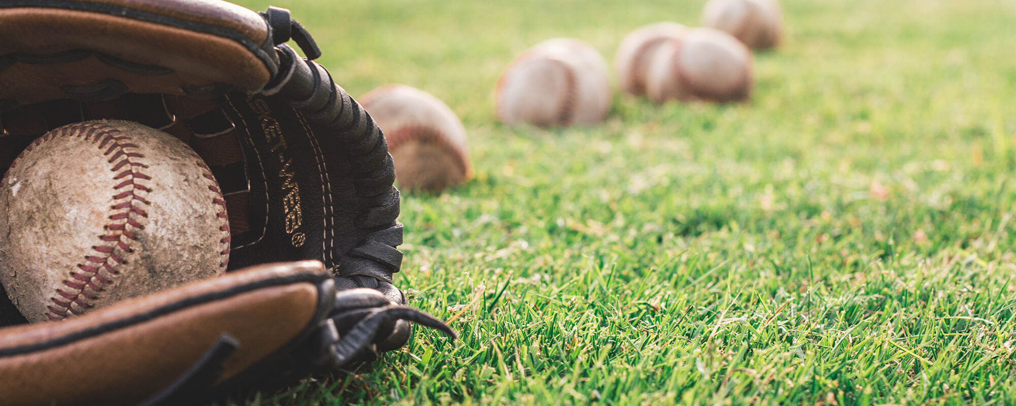 Close Up of Baseballs with a Baseball Glove