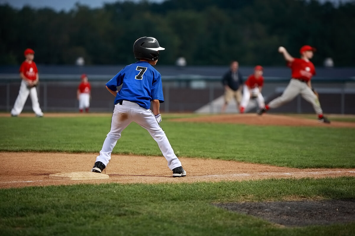 Youth baseball player waiting to run